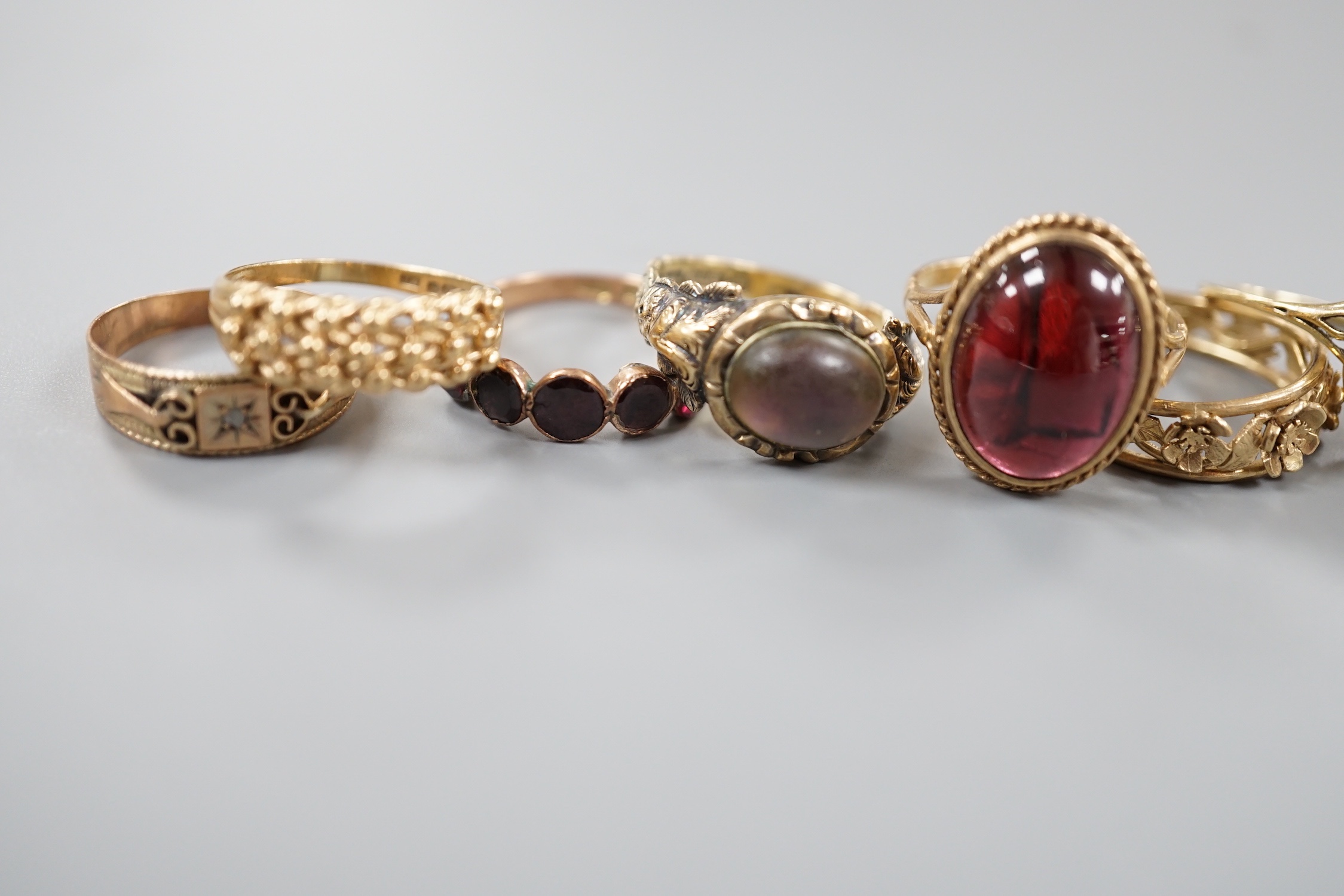 Six assorted Victorian and later 9ct gold or 9ct gold and gem set dress rings, including cabochon garnet and foliate band and a yellow metal and moonstone ring.